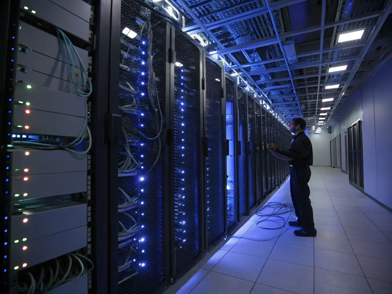 A secure data center environment with servers and cybersecurity professionals, illustrating companies modernizing their IT security.